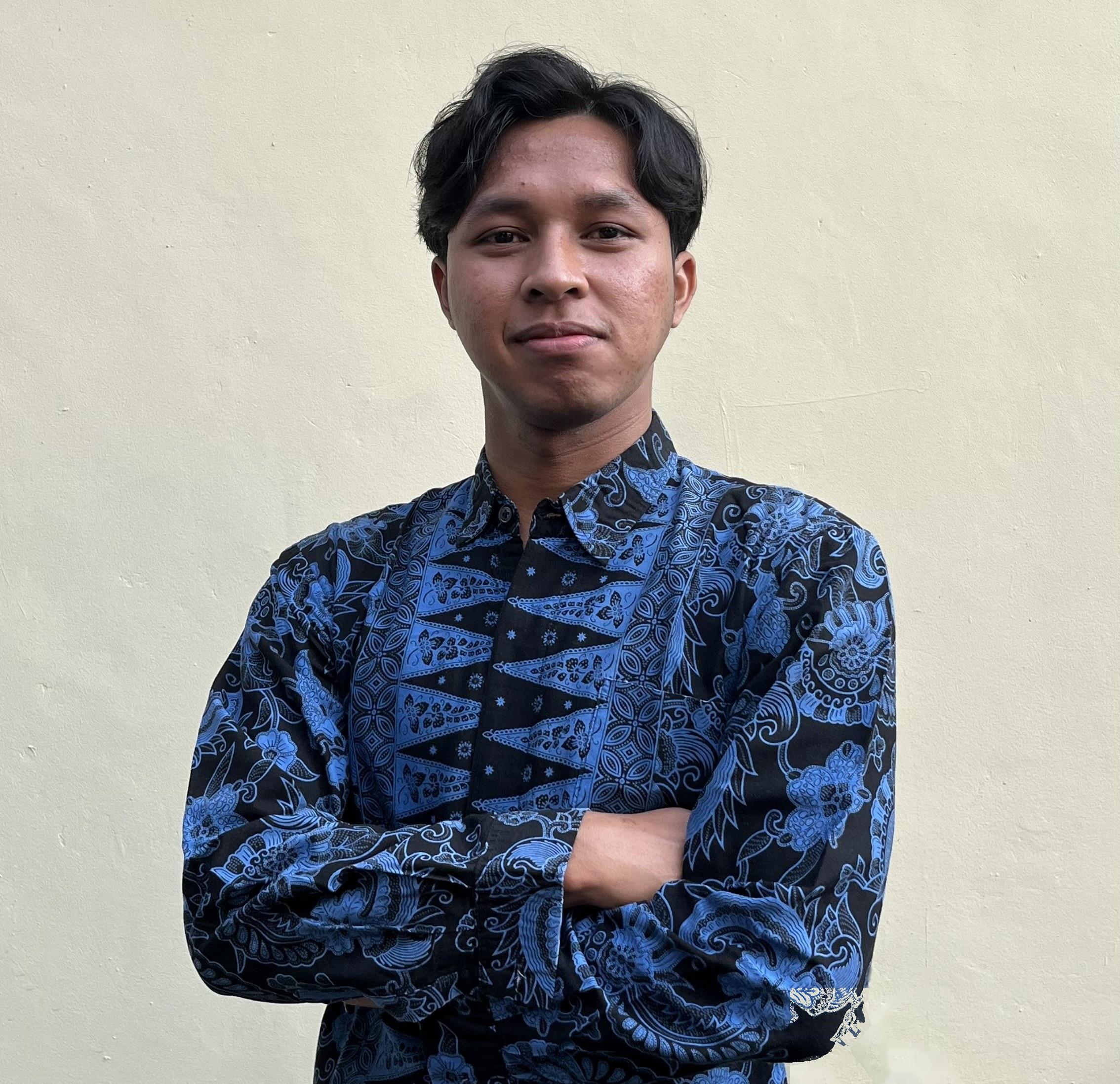 Ari Hendrawan wearing a blue batik shirt